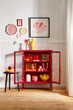 a red bookcase in the corner of a room