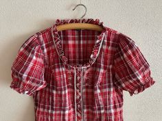 Dirndl Shirt Women's Trachten Blouse Loden Shirt Red Plaid Checkered German Austrian Alpen Oktoberfest Peasant Bavarian Folk Style Large Size Label size: 44/46 EUR,18 UK Shown on model L Measurements (lying flat): Length: 23"/ 58.5 cm Shoulders: 16"/ 41 cm Pit to pit: 22"/ 56 cm Sleeve: 10"/ 25.5 cm Please check measurements to insure a proper fit. Remember to allow yourself some extra room for movement. You can compare these with something from your closet that fits you well. Condition: Great Vintage Condition Material: 47%cotton,52%polyester,1%elastane N.B. Color may slightly differ from picture SHIPPING * I ship worldwide via Priority mail  * Items are shipped 1 - 3 business days after receiving the payment. * I ship from Europe, so please allow 2 to 3 weeks for the package to arrive if Dirndl Shirt, Folk Style, Folk Fashion, Red Plaid, Label Sizes, Womens Clothing Tops, Blouses For Women, Womens Shirts, Bathing Beauties