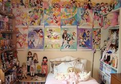 a bed room with a neatly made bed and lots of cartoon pictures on the wall