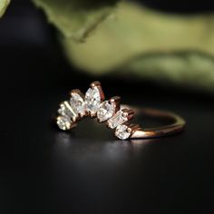 "A subtle yet striking arrangement of marquise, baguette and round cut diamonds, forming a half halo that would stack perfectly with your round or oval diamond engagement ring, this ring will add the right amount of royal to your set. Crafted in solid 14K Rose Gold, this ring looks stunning worn by itself or stacked! * Diamond Wt. : 0.27-0.30 Cts * Color-Clarity Grade : G-H-I, Vs-Si * Gold - 14kt, solid gold If you like this ring, please press \"Pin it\" button on the top of your screen. Find us Curved Stacked Wedding Bands, Contour Ring Stack, Curved Stacking Ring, Curved Wedding Band With Baguettes, Diamond Contour Band, Gold Curved Wedding Band, Pin It Button, Wedding Band Marquise, Diamond Stacks