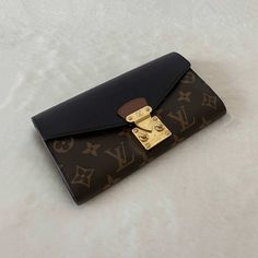 Description: Louis Vuitton Monogram Noir Pallas Wallet Includes Dustbag and Box Condition: Pre/Loved in Good Condition. Minor Scratches at Hardware and Leather Wrinkling Estimated Retail: $1,140 Details: Monogram Coated Canvas / Black LeatherGold-Tone Hardware4 Compartments, One with Zipper10 Card SlotsPush Button Closure Measurement: Width 19cm / Height 11cm / Depth 2cm For more details on this item, contact us on bagsarenaon@gmail.com or Luxury Designer Wallets For Shopping, Louis Vuitton Purse Wallets, Designer Luxury Wallets With Logo Plaque, Wallet Purse Louis Vuitton Official, Luxury Black Monogram Canvas Wallet, Lv Wallet Women Louis Vuitton, Louis Vuitton Wallet Women Black, Luxury Wallets With Logo For Everyday Use, Luxury Elegant Monogram Wallets