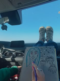 someone is sitting in their car and drawing