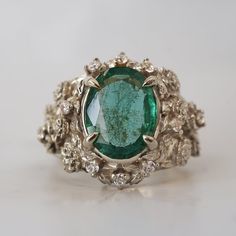 Read about our payment plans before proceeding. Our "Tulip Majesty Emerald Bloom Ring." A mesmerizing oval emerald, reminiscent of a lush oasis, is embraced by delicate tulip petals, accented by sparkling diamonds. Experience the essence of spring's romance captured in this timeless treasure. Perfect for those who seek nature's elegance and enduring beauty. Crafted by skilled hands, this ring is available in your choice of 14K and 18K yellow gold, rose gold, and white gold. All emeralds are natural so it can differ from the image. All orders come in our Tippy Taste ring box. This ring is handmade and designed in NYC. 14K or 18K solid gold Natural 10*8mm oval emerald. Approx. 2.5ct Natural diamonds. SI clarity, GH color, 0.08ct total carat weight ** Tippy Taste Heirloom Collection is made t Exquisite Oval Emerald Ring With Rose Cut Diamonds, Luxury Gold Oval Emerald Ring, Unique Oval Emerald Ring, Exquisite Green Oval Emerald Ring, Exquisite Oval Green Emerald Ring, Luxury Oval Emerald Ring Collectible, Nature-inspired Oval Emerald Ring, Nature-inspired Green Oval Emerald Ring, Luxury Oval Emerald Jewelry