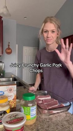 a woman standing in front of a kitchen counter with food on it and the words juicy crunchy garlic pork chops