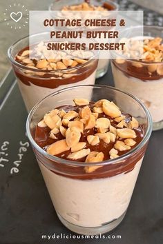 three desserts in small glass bowls with nuts and chocolate on top, sitting on a table