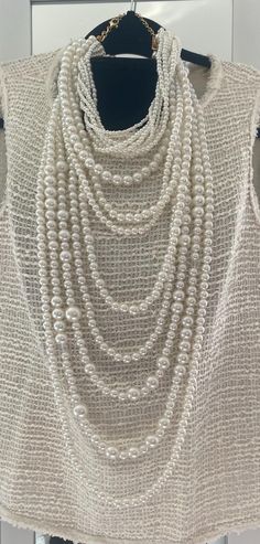 Stunning long multi-strand statement pearl necklace. Featuring a trendy layered chunky choker design. This cascade necklace showcases a beautiful waterfall of faux pearls in varying sizes, from delicate 2mm to bold 20mm. Perfect for adding a touch of elegance to any outfit, it's the ideal accessory for both casual and formal occasions. Make a statement with this eye-catching piece that effortlessly blends classic charm with modern flair. The necklace measures:  choker size 18" +4" (48 cm+10cm) Longest row : 46" (117 cm) Necklace drop: 23"(58cm) ----If you have any question please contact me---- I am inviting you to explore and enjoy my jewelry store; perhaps you will discover something unique for yourself or as a gift for someone special in your life. Thank you! https://www.etsy.com/shop/B Elegant Multi-strand Pearl Necklace, Cream Multi-strand Pearl Necklace, White Multi-strand Pearl Drop Necklace, Luxury Multi-strand Pearl Necklace, Luxury White Multi-strand Pearl Necklace, Cascade Necklace, Chunky Choker, Choker Designs, Pearl Statement Necklace