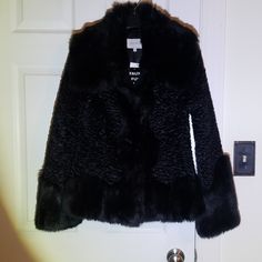 Beautiful Faux Fur Jacket Purchased At Sak's 5th Ave. I Have A Medium Only**** Medium Sleeves Length-25 Inches Chest -31 Collar To Bottom Of Coat -27 Inches Large Size Arms-26.5 Inches Chest-37 Inches Collar To End Of Coat-29 Inches There Are Hooks Inside Of Coat Hidden In The Faux Fur Hook And Hoop Is On The Opposite Side Please Email Me With Any Questions. Thank You ***Sale Is A Final Sale**** **Large Is Sold, Medium Only Is Available **& Fitted Black Fur Coat For Fall, Fitted Black Fur Coat For Spring, Black Faux Fur Outerwear For Work, Elegant Black Fur Coat With Faux Fur Trim, Classic Black Fur Coat With Faux Fur Trim, Black Faux Fur Coat With Faux Fur Trim, Black Luxury Faux Fur Outerwear, Long-sleeved Faux Fur Coat With Fur Trim, Faux Fur Jacket