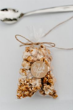 a bag filled with popcorn sitting next to a spoon