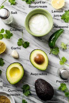 avocado, cilantro, and other ingredients on a marble surface