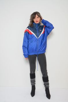 "80's Rukka zipper windbreaker. Sports jacket, rainproof. - Label: Rukka  - Era: 1990s  - Color:  blue - Fabric: shell: 100% polyamid, lining: 100% polyester - Condition: very good. clean, no tears, no rips. Ready to wear. - Tag Size: 164 - Fits size: small/medium MEASUREMENTS:  *Bust: 49.6\" (126 cm) *Waist: 43.3\" (110 cm)  *Sleeve Length: 22.2\" (57 cm) *Length: 26\" (66 cm) Model is 5.7 feet (174 cm) height." Blue Sportswear Windbreaker For Winter, Blue Retro Windbreaker For Streetwear, Retro Blue Windbreaker For Streetwear, 90s Blue Windbreaker For Streetwear, 90s Blue Windbreaker For Fall, Vintage Nylon Track Jacket For Winter, 90s Style Sports Windbreaker For Fall, Vintage Blue Nylon Track Jacket, Retro Blue Nylon Windbreaker