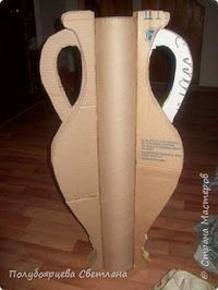 an open cardboard vase sitting on top of a hard wood floor