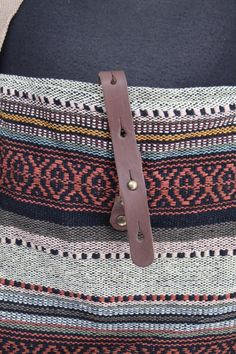 a close up of a bag with a belt on it's back pocket,