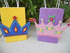 three small paper bags with crowns on them