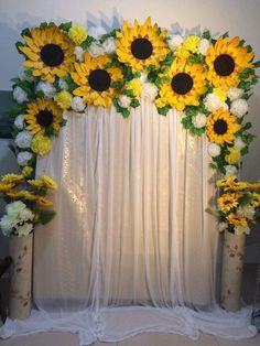 sunflowers and white carnations decorate the backdrop for a wedding ceremony