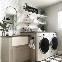 a washer and dryer in a room with white brick walls, black and white checkered flooring