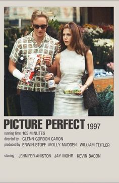 a man and woman walking together in front of an advertisement for the movie picture perfect