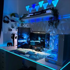 RGB gaming room with LED lights, a modern gaming desk, and colorful neon accents for a dynamic and immersive experience 2 Desk Gaming Setup, White And Blue Gaming Setup Aesthetic, Sky Blue Gaming Setup, Navy Blue Gaming Setup, White And Blue Setup, Cyan Gaming Setup, Pc Gaming Setup Blue, Ocean Themed Gaming Setup, Blue Setup Gaming