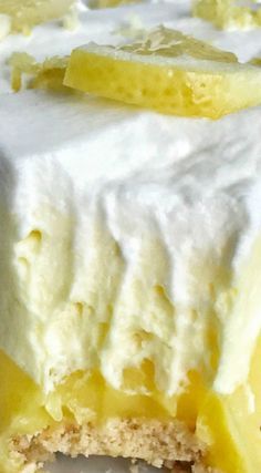 a piece of cake with white frosting and lemon slices