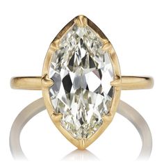 a yellow gold ring with an oval cut diamond