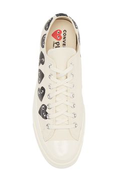 Cool vintage style elevates a street-ready low-top sneaker with iconic heart graphics somersaulting along the welt. This collaboration between Comme des Garçons PLAY and Converse features classic Chucks styling with a playful, quirky twist. Lace-up style Removable insole Textile upper and lining/rubber sole Imported Asian Owned/Founded Heart Converse Low Top, Cdg Converse Low Top, White Converse Comme Des Garcons, Grey Converse Comme Des Garcons, Converse Play Comme Des Garcons, Chucks Style, Play X Converse, Heart Graphics, Gender Inclusive