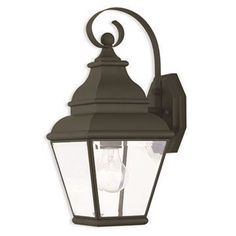 a light that is on the side of a wall mounted fixture with an iron frame