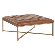 a brown leather ottoman sitting on top of a metal frame