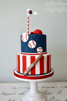 a baseball themed cake with a bat, glove and ball on the bottom tier is decorated in red, white, and blue