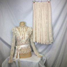 Td4 Vintage 70’s Cream Lace Victorian Style Blouse & Skirt Set. Blouse Lace Ruffles Pearl Button Up Back High Neck Elastic Waist With Ribbon Tie Elastic Wrist. Skirt Lined With Elastic Waist. Size 3 Preowned Condition, Has No Visible Flaws Measurements Laying Flat May Vary Slightly Top Is Small See Measurements Dry Clean Only Same Or Next Day Shipping Offers Welcome 1993 Vintage Fitted Wedding Bottoms, Fitted Cream Lace Sets, Cream Lace Fitted Sets, Vintage Fitted Long Skirt, Vintage Fitted Pleated Skirt, Fitted Vintage Set With Lace Trim, Fitted Vintage Sets With Lace Trim, Vintage Skirt For Spring Wedding, Vintage Fitted Cream Bottoms