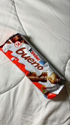 a candy bar sitting on top of a bed