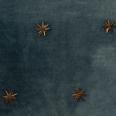 four gold stars on a blue velvet background