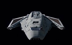 an overhead view of a space shuttle in the dark with its landing gear down and it's door open