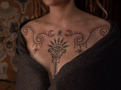 a woman with a tattoo on her chest