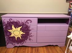 a purple dresser sitting on top of a hard wood floor