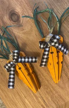 two wooden crosses with black and white checkered bows