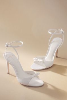 Elevate your ensemble with a touch of sophistication in every step with the Black Suede Studio Albie Bow Heels, showcasing a sleek design and charming bow detail. | Albie Bow Heels by Black Suede Studio in White, Women's, Size: 10, Leather/Satin at Anthropologie Graduation Heels, Elegant Wedding Shoes, Feather Heels, Sequin Heels, Black And White Heels, Ivory Wedding Shoes, Crystal Heels, Bridal Heels, Lace Heels