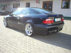 a black car parked in front of a building