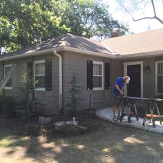 a man standing in front of a house