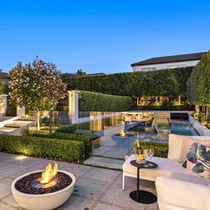 an outdoor fire pit in the middle of a patio