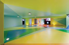 there are two pictures of the inside of a building with multicolored walls and floors