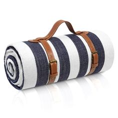 a roll of blue and white striped fabric with brown leather straps on it's side