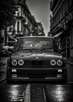 a black and white photo of a car parked on the street