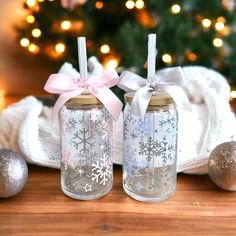 two glass jars with snowflakes on them