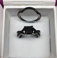 an open box with two rings in it and the ring is black onyxite