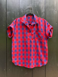 - 1980s navy and red checked camp shirt - Vintage, no tag, feels like a poly-cotton blend - Best fit for a Medium, measures 21" across the chest and 25" from shoulder to hem Unsure about fit or condition? Return any item for a full refund - shipping both ways is always free. Plaid Camp Collar Shirt For Summer, Plaid Relaxed Fit Camp Shirt For Summer, Plaid Collared Short Sleeve Shirt With Relaxed Fit, Relaxed Fit Plaid Camp Shirt For Summer, Collared Plaid Short Sleeve Shirt With Relaxed Fit, Plaid Collared Top For Summer, Casual Plaid Camp Shirt With Camp Collar, Summer Collared Plaid Flannel Shirt, Summer Plaid Collared Flannel Shirt