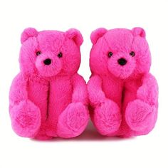 two pink teddy bears sitting next to each other