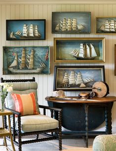 a living room filled with furniture and pictures on the wall