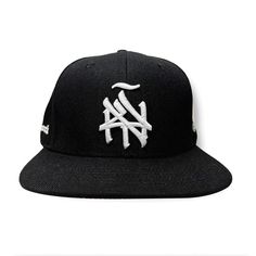 Introducing our New York (ÑY) Hometown Logo Snapback Hat – featuring our remixed 3d embroidered logo with a tilde design on the front, under brim is gray, the right side features our Nueva York "Split Logo" design and the left side highlights a "Latinos Unidos" emblem with flags from Colombia, Puerto Rico, Dominican Republic and Mexico. Our “NY Hometown Logo” intertwines the "N" and "Y," inspired by the Yankees and Mets interlocking insignias; merging classic sports heritage with a handmade, sty Streetwear Hat With Curved Brim, Black Fitted Hat With Letter Print For Streetwear, Black Hats With Embroidered Logo For Streetwear, Urban Trucker Hat With Embroidered Logo For Streetwear, Streetwear Fitted Hat With Embroidered Logo, Adjustable Trucker Hat With Embroidered Logo For Streetwear, Black Hip Hop Fitted Hat For Streetwear, Urban Hat With Curved Brim, Urban Style Curved Brim Hat