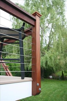 a wooden swing set in the middle of a yard