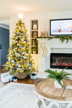 a living room with a christmas tree and fireplace