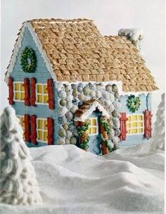 a gingerbread house with snow on the ground